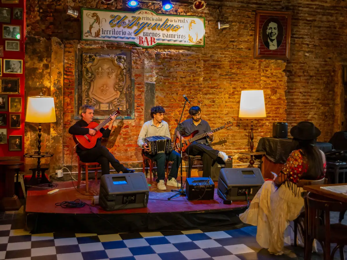 A guitarist, bandoneón player and bassist performing at a Buenos Aires tango bar